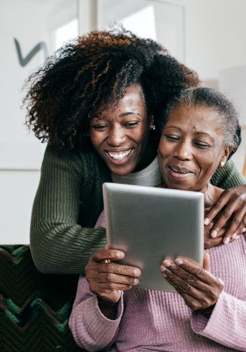 caregiver helping elderly with tech