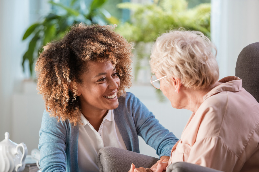 caregiver smiling at elderly