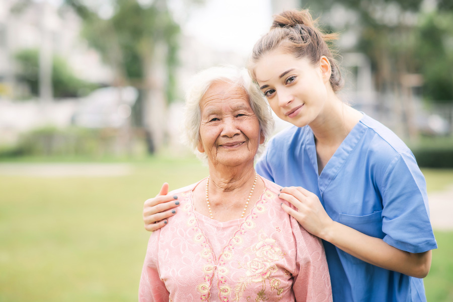 caregiver-with-elderly-mobile About us Lend a Hand - picture of caregiver with elderly