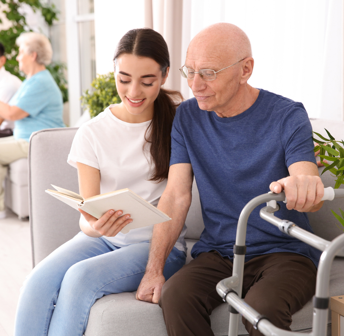 caregiver reading to elderly man