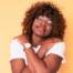 Self-care for caregivers, happy caregiver smiles contently while giving herself a hug