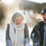 As a result of good winter safety practices, an elderly couple can enjoy time outside in the snow.
