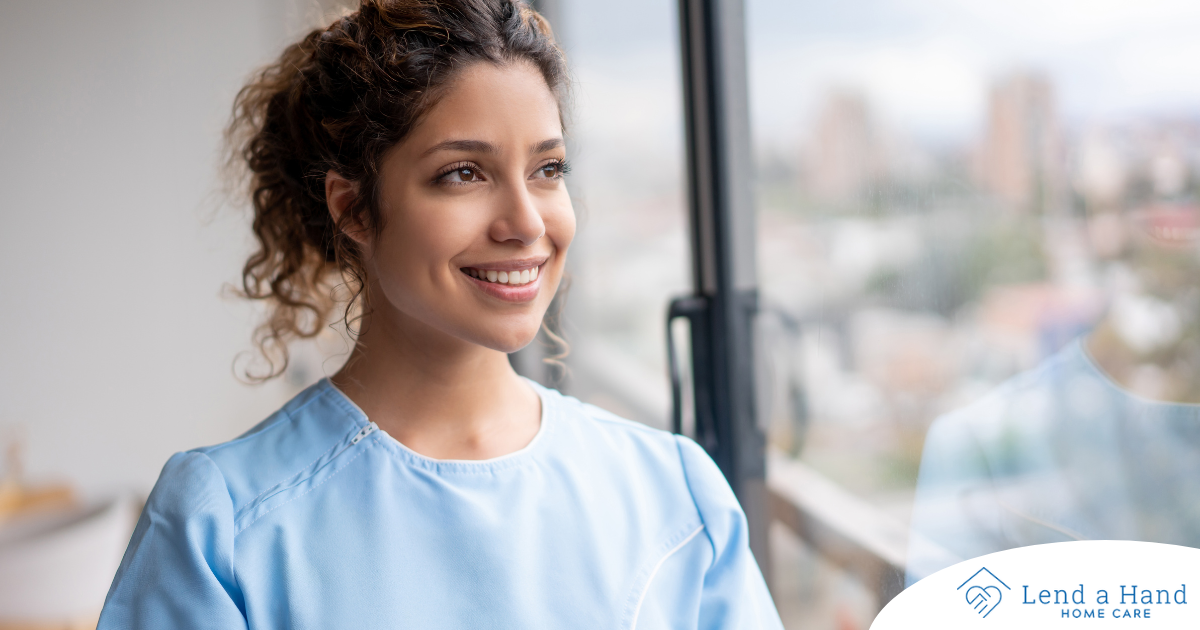 A woman in scrubs smiles, representing the satisfaction that can come with transitioning into a professional caregiving career.