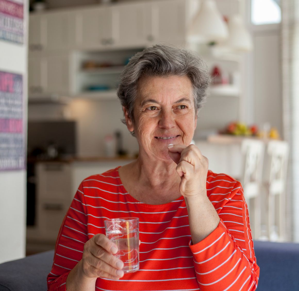 A senior taking a pill represents medication supervision in Reno.