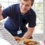 Professional caregiving involves helping clients with iADLs and ADLs as demonstrated by this caregiver helping a client by bringing a meal.